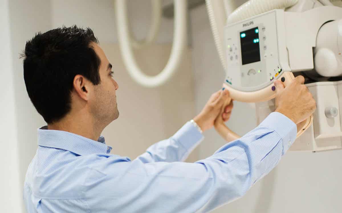 a man operating a digital x-ray machine